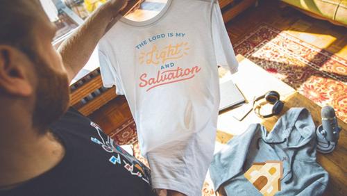 person unboxing their own custom church merch